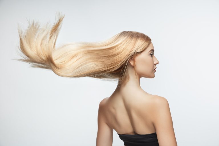 Beautiful model with long smooth, flying blonde hair