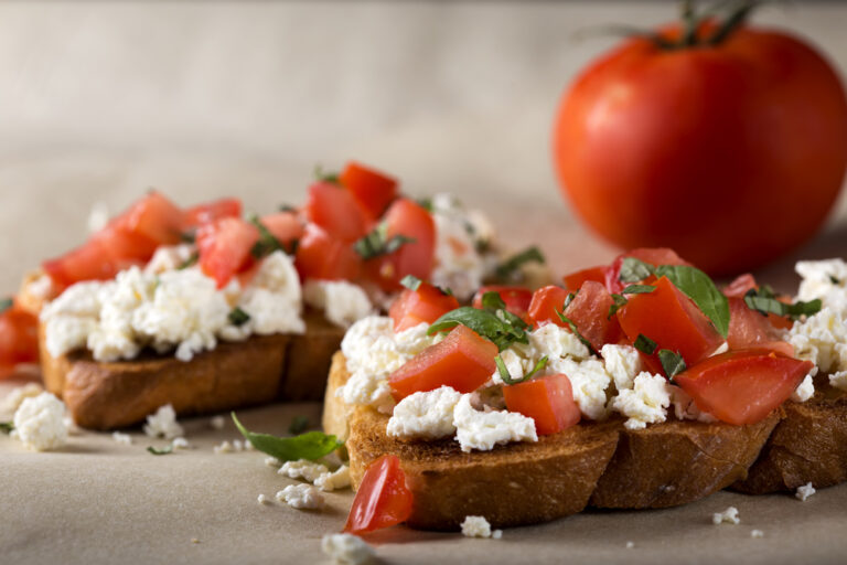 Bruschetta with roasted tomatoes, cheese and herbs