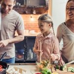 Cute,Little,Girl,And,Her,Beautiful,Parents,Are,Smiling,While